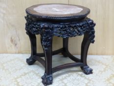 A CHINESE MARBLE TOPPED HARD WOOD STAND, THE WAVY CIRCULAR TOP WITH A BEAD CARVED EDGE, THE APRON