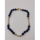 A ROW OF LAPIS, PEARL AND GOLD BEADS. THE BOW CLASP STAMPED D925, THE BEADS ASSESSED AS 14ct. LENGTH