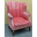 A 19th C. MAHOGANY ARMCHAIR, THE ROUNDED BACK UPHOLSTERED WITH RIBS OF PINL DAMASK THE LEGS ON BRASS