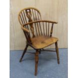 AN 19th CENTURY OAK AND ELM LOW BACKED WINDSOR CHAIR WITH CRINOLINE STRETCHER