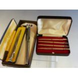 A CASED SET OF FOUR STERLING SILVER PROPELLING PENCILS MARKED WITH THE SUITS OF PLAYING CARDS, A