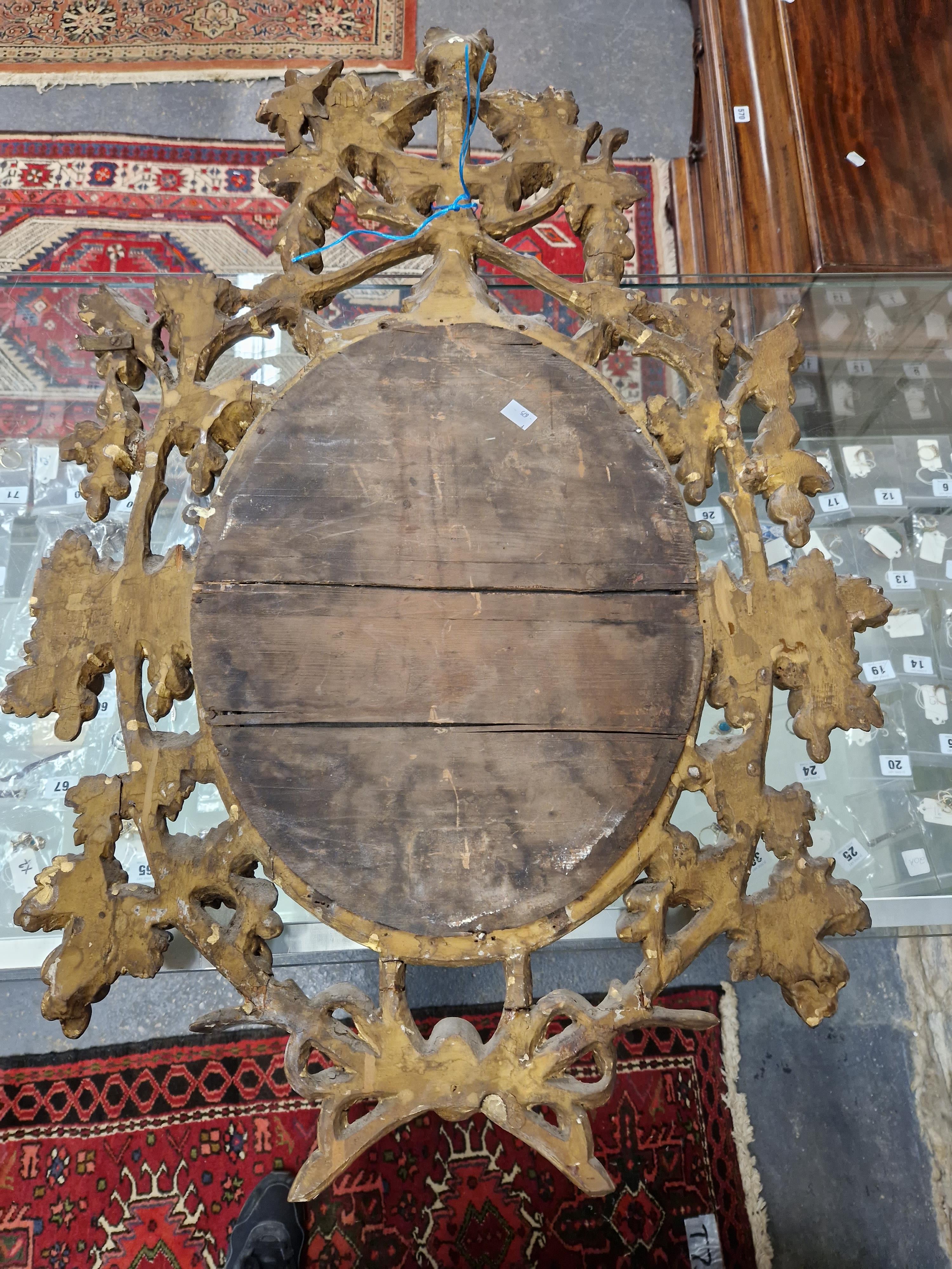 AN OVAL MIRROR IN A LATE 18th C. GILT FRAME PIERCED AND CARVED WITH GRAPE VINES. 95 x 64cms. - Image 12 of 12