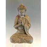 A BRONZE FIGURE OF THE BUDDHA SEATED CROSS LEGGED HIS HANDS CLASPED BEFORE HIS CHEST, HIS HEAD