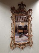A CHINESE CHIPPENDALE STYLE GILT WOOD FRAMED MIRROR, THE RECTANGULAR PLATE FLANKED BY COLUMNS AND