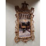 A CHINESE CHIPPENDALE STYLE GILT WOOD FRAMED MIRROR, THE RECTANGULAR PLATE FLANKED BY COLUMNS AND