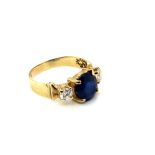 AN OVAL SAPPHIRE AND DIAMOND THREE STONE RING. THE OVAL SAPPHIRE 9.5 X 8.2 X 5.0mm, THE DIAMONDS 4.3