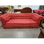 A VINTAGE CHESTERFIELD BUTTON UPHOLSTERED IN RED. W 241 x D 95 x H 78cms.