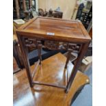 A CHINESE HARDWOOD OCCASIONAL TABLE, THE APRON ON THREE SIDES CENTRED BY A CASH MEDALLION. W 33 x