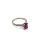 A PLATINUM HALLMARKED, PINK SAPPHIRE AND DIAMOND RING. THE PINK SAPPHIRE MEASUREMENTS 7.4 X 4.6mm.