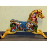 A VINTAGE FIBRE GLASS FAIR GROUND CAROUSEL HORSE PAINTED WITH UNION FLAGS ON ITS YELLOW NECK AND