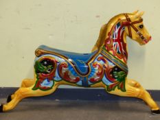A VINTAGE FIBRE GLASS FAIR GROUND CAROUSEL HORSE PAINTED WITH UNION FLAGS ON ITS YELLOW NECK AND