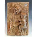 A 19th C. TERRACOTTA PLAQUE MODELLED IN RELIEF WITH THE MADONNA HOLDING HER CHILD. 41 x 27cms.
