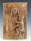 A 19th C. TERRACOTTA PLAQUE MODELLED IN RELIEF WITH THE MADONNA HOLDING HER CHILD. 41 x 27cms.