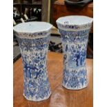 TWO SIMILAR DUTCH DELFT BLUE AND WHITE RIBBED WAISTED CYLINDRICAL VASES PAINTED WITH BIRDS, ROCKS