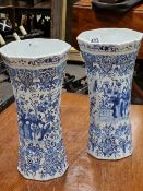 TWO SIMILAR DUTCH DELFT BLUE AND WHITE RIBBED WAISTED CYLINDRICAL VASES PAINTED WITH BIRDS, ROCKS