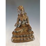 A TIBETAN BRONZE TARA SEATED CROSS LEGGED ON A DOUBLE LOTUS THRONE. H 18cms.