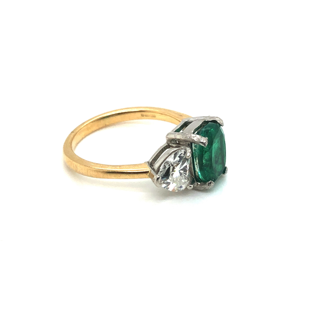 A 18ct GOLD HALLMARKED EMERALD AND DIAMOND RING. THE OVAL EMERALD FLANKED BY HEART CUT DIAMONDS. - Image 3 of 3