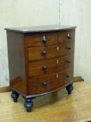 A 19th C. MAHOGANY MINIATURE BOW FRONT CHEST OF TWO SHORT AND THREE GRADED LONG DRAWERS, EACH WITH