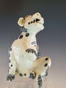 A JAPANESE ARITA BLUE AND WHITE SPOTTED BUDDHIST LION SEATED WITH A FOREPAW RAISED AND SNARLING. H