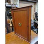 AN EARLY 20th C. MAHOGANY SMOKERS CUPBOARD WITH AN ARMORIAL ON THE DOOR BEFORE THE DEMILUNE BACK ,