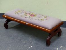 A MAHOGANY DOUBLE STOOL BY PAUL RANTAL, ST JOHN N.B CANADA, WITH A MAUVE GROUND FLORAL NEEDLE WORK