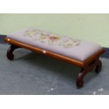 A MAHOGANY DOUBLE STOOL BY PAUL RANTAL, ST JOHN N.B CANADA, WITH A MAUVE GROUND FLORAL NEEDLE WORK