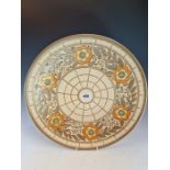 A CHARLOTTE RHEAD FOR BURSLEY WARE DISH SLIP TRAILED WITH YELLOW CENTRED ORANGE FLOWERS ENCLOSING