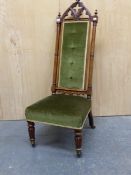 A VICTORIAN WALNUT NEOGOTHIC NURSING CHAIR UPHOLSTERED IN OLIVE GREEN VELVET, THE LANCET ARCHED
