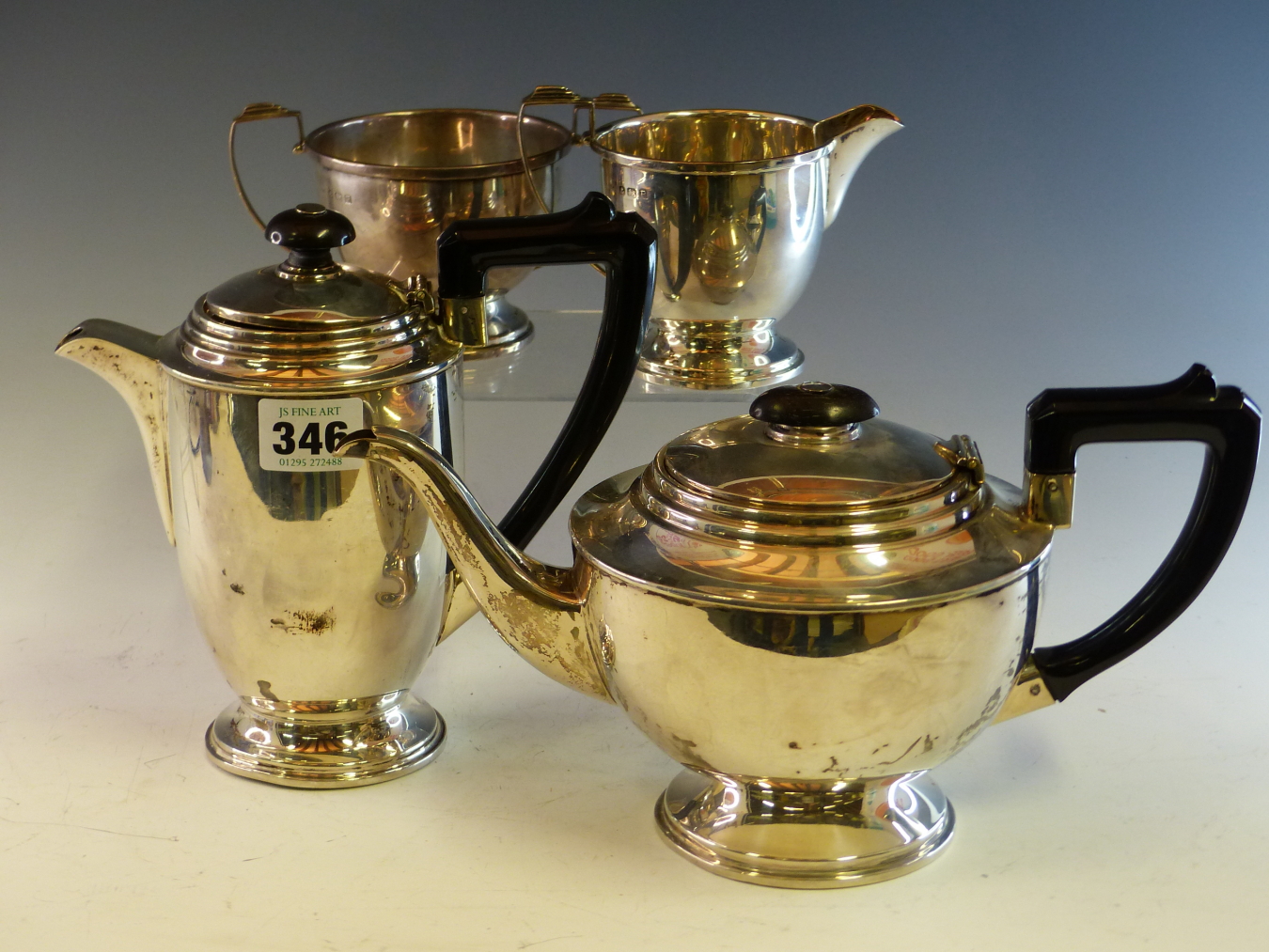 A SILVER FOUR PIECE TEA SET BY ERNEST HAYWOOD, BIRMINGHAM 1939, EACH WITH STEPPED CIRCULAR FEET, THE