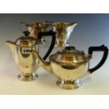 A SILVER FOUR PIECE TEA SET BY ERNEST HAYWOOD, BIRMINGHAM 1939, EACH WITH STEPPED CIRCULAR FEET, THE