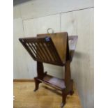 A 19th C. OAK MUSIC AND BOOK STAND, THE SLATTED SIDES OPENING OUT FROM THE CENTRAL BRASS HANDLE TO