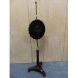 A VICTORIAN ROSEWOOD AND BRASS POLE SCREEN, THE SHAPED ROUND PAPIER MACHE SCREEN INLAID WITH