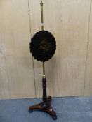 A VICTORIAN ROSEWOOD AND BRASS POLE SCREEN, THE SHAPED ROUND PAPIER MACHE SCREEN INLAID WITH