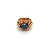 A 9ct ROSE GOLD HALLMARKED AND BLUE DIAMOND GENTS GYPSY SET RING. THE BLUE ROUND BRILLINAT CUT