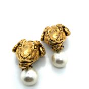 A PAIR OF GOLD PLATED GRAECO ROMAN RAM'S HEAD AND FAUX PEARL CLIP ON DROP EARRINGS. SIGNED 1991, MMA