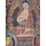 A TIBETAN THANGKA PAINTED ON TEXTILE WITH THE BUDDHA CENTRAL TO TWO BODHISATTVAS BELOW AND TWO MONK