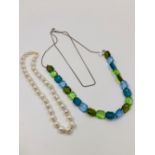 A CELINE MULTI FACET BEADED NECKLACE COMPLETE WITH SIGNATURE CHARM WITH SILVER ADJUSTABLE CHAIN.