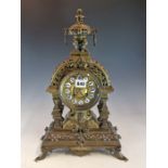 A 19th C. FRENCH BRASS MANTLE CLOCK SURMOUNTED BY A RING HANDLED URN, THE DIAL WITH ENAMEL NUMERAL