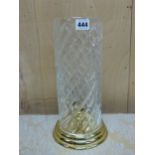 A BRASS CANDLESTICK WITH WATERFORD CYLINDRICAL CUT GLASS STORM SHADE. H 32.5cms.