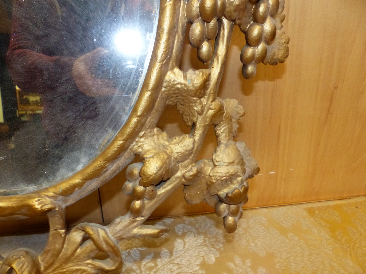 AN OVAL MIRROR IN A LATE 18th C. GILT FRAME PIERCED AND CARVED WITH GRAPE VINES. 95 x 64cms. - Image 7 of 12