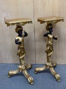 A PAIR OF DECORATIVE NUBIAN BLACKAMOOR GILT TRIPOD STANDS, EACH FIGURE HOLDS A BUNCH OF GRAPES AND A