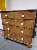 A VICTORIAN MAHOGANY CHEST OF TWO SHORT AND THREE LONG DRAWERS EACH WITH WHITE CERAMIC KNOB