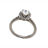 A PLATINUM HALLMARKED DIAMOND HALO RING. THE CENTRAL DIAMOND MEASURING 4.7mm,WITHIN A DIAMOND HALO