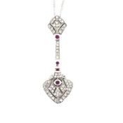 A 9ct HALLMARKED WHITE GOLD DIAMOND AND RUBY ARTICULATED PENDANT SUSPENDED ON A 9ct WHITE GOLD