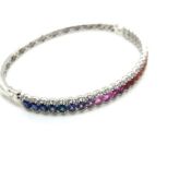 A RAINBOW MULTI SAPPHIRE AND DIAMOND HINGED BANGLE. STAMPED 18K, ASSESSED AS 18ct GOLD. APPROX