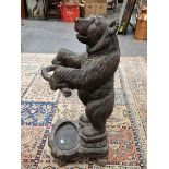 A COMPOSITION BEAR STICK STAND MODELLED AND PAINTED IN THE BLACK FOREST STYLE. H 77cms.