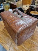 A CROCODILE GLADSTONE BAG STYLE DRESSING CASE BY J G VICKERY WITH A WALLET INSIDE CONTAINING TWO