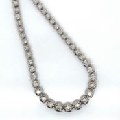 A HALLMARKED 9ct GOLD GRADUATED DIAMOND TENNIS LINE NECKLACE. APPROX ESTIMATED STATED WEIGHT 6.