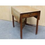 A GEORGE III MAHOGANY PEMBROKE TABLE WITH A DRAWER TO ONE END, THE CHANNELLED LEGS JOINED BY A