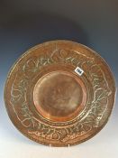 AN ARTS AND CRAFTS COPPER DISH WORKED WITH A BAND OF LEOPARDS WALKING AROUND THE DISHED CENTRE. Dia.